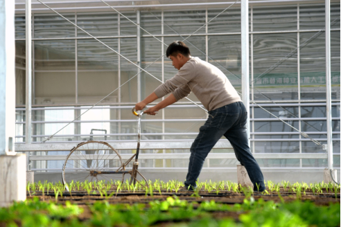 FCC Commissioner Brendan Carr standing next to and speaking to Donald Trump, who is wearing a "Make America Great Again" hat.