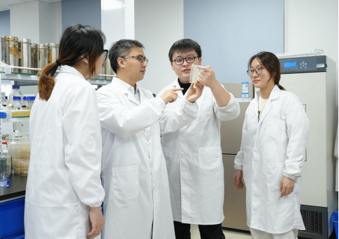 Woman holding her forehead while working at a home office